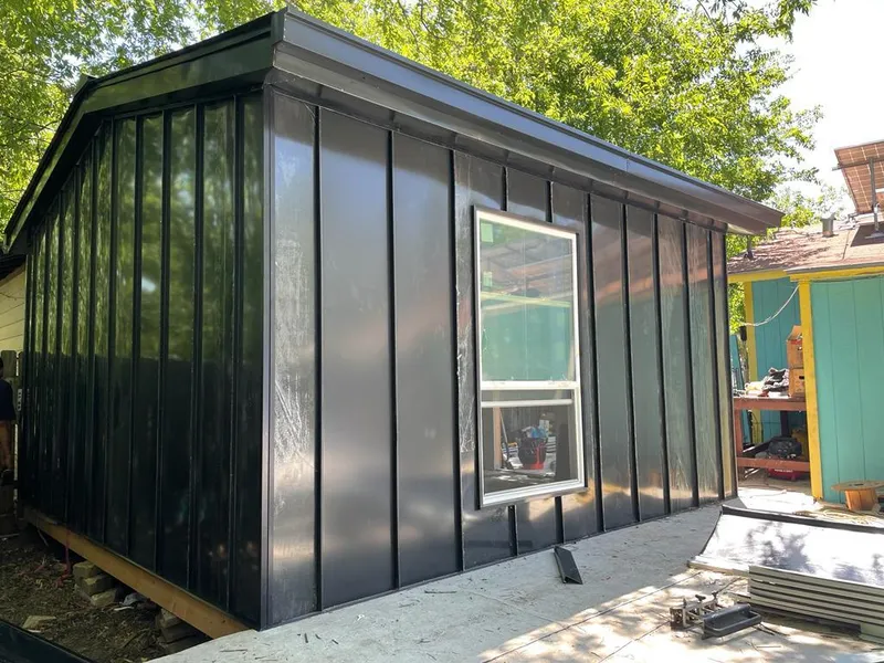 Black standing seam metal wall panels for Roof Inspection in University