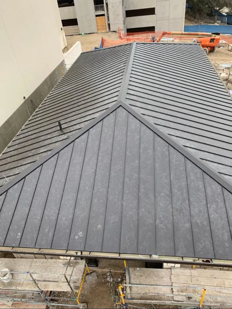 Commercial metal roof construction with crane equipment in University